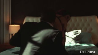 Interracial couple on a bed in a lit studio scene
