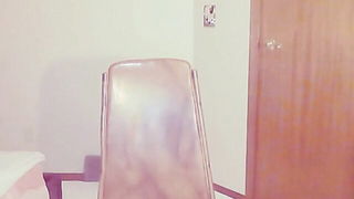 Performer on a bed in a softly lit room