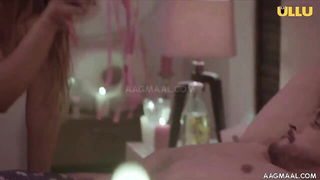 Performer on a bed in a softly lit room